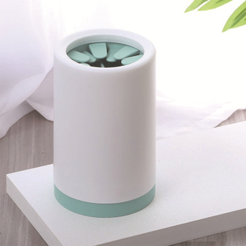 dog paw washer cup in mint color with silicone bristles visible
