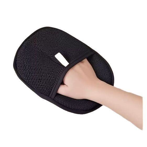 hand slipping into black mesh deshedding glove strap